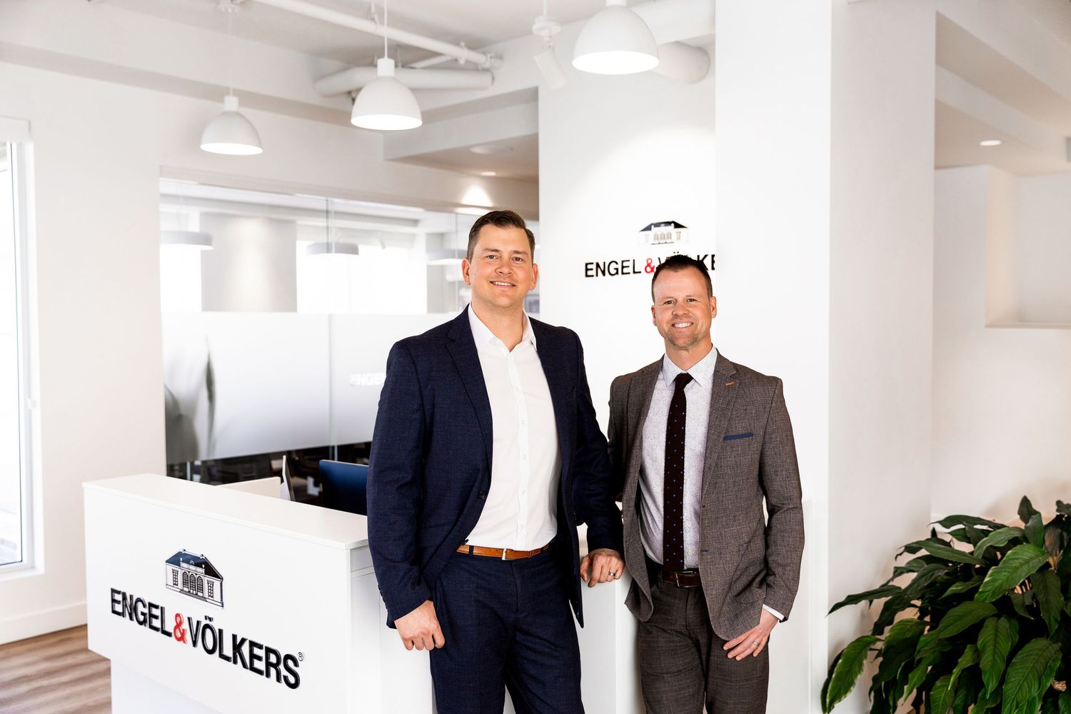 Luxury corporate branding photo of four professionals at Engel & Völkers, styled business portraits showcasing real estate team photography.