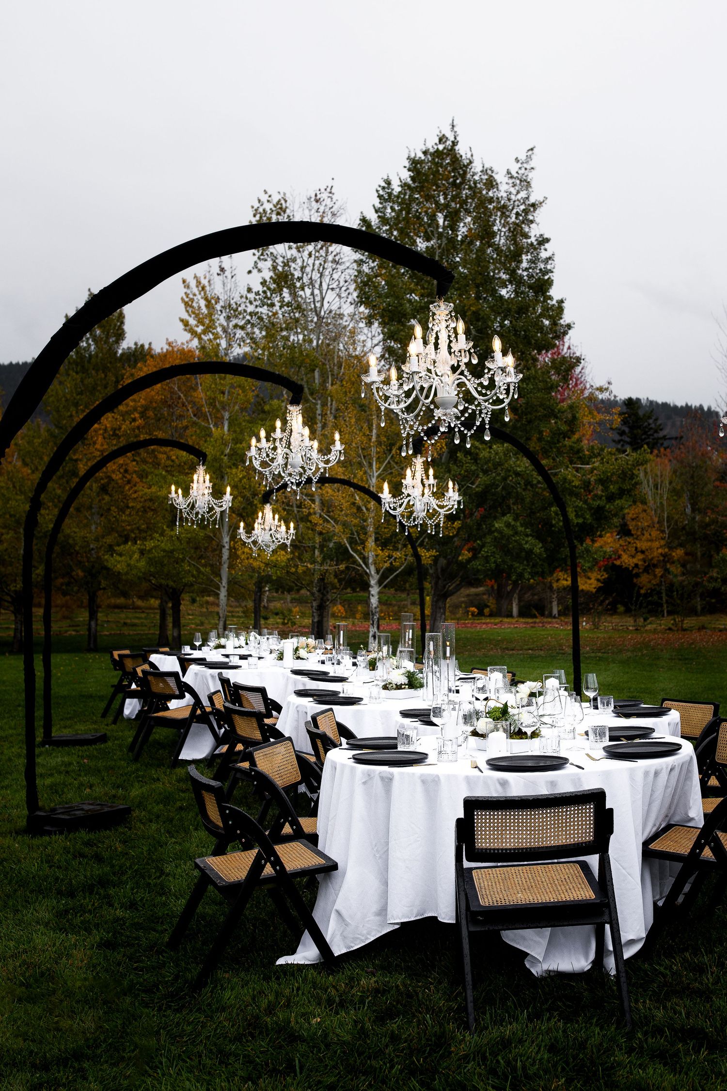 Chandeliers and a tablescape of an elegant and luxury wedding venue in Penticton BC, taken by a professional wedding photographer.
