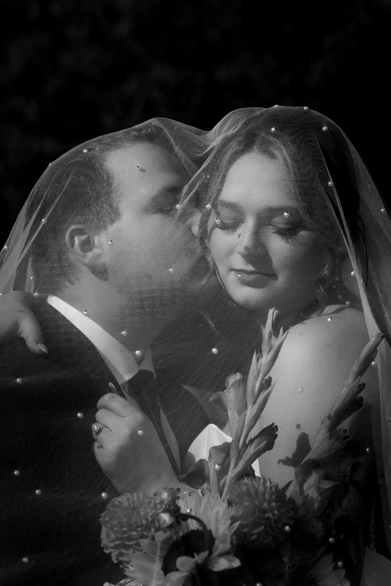 Luxury wedding photo of groom kissing bride’s cheek under veil, capturing romantic, intimate, and stylish bridal couple photography.