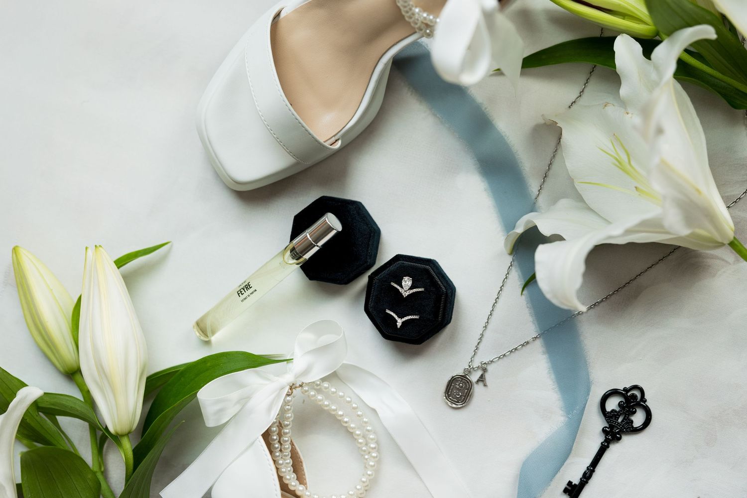 Flat lay of bridal details, including wedding accessories and attire, captured by a professional wedding photographer for elegant wedding.