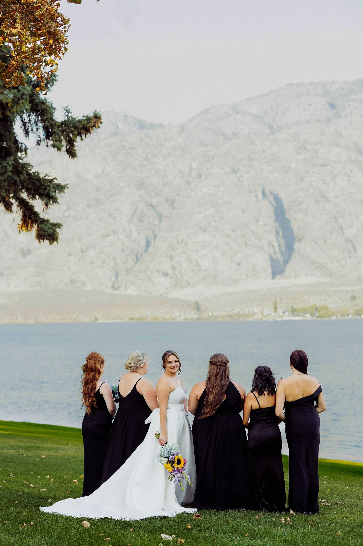 Wedding photographer captures bride and wedding party at the Watermark Beach Resort in Osoyoos during the Fall wedding season.