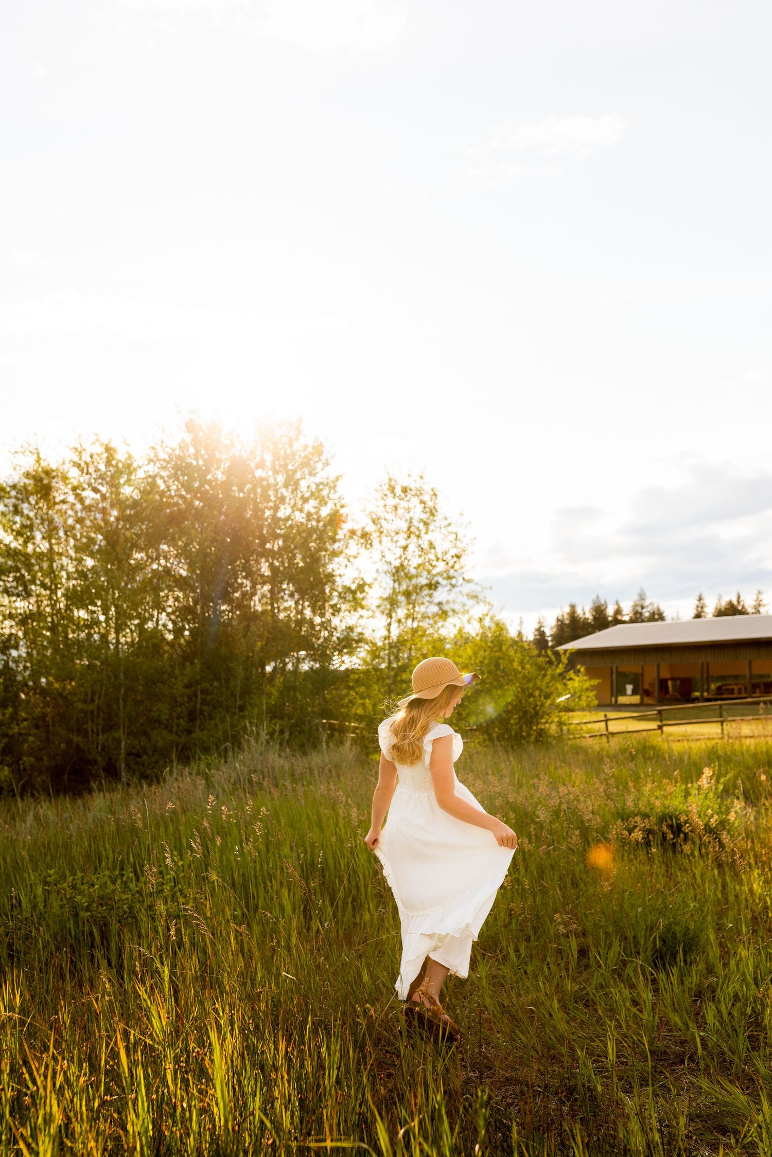 Golden hour portrait of a girl dancing in a field, capturing joyful, whimsical moments with warm, vibrant luxury lifestyle photography.