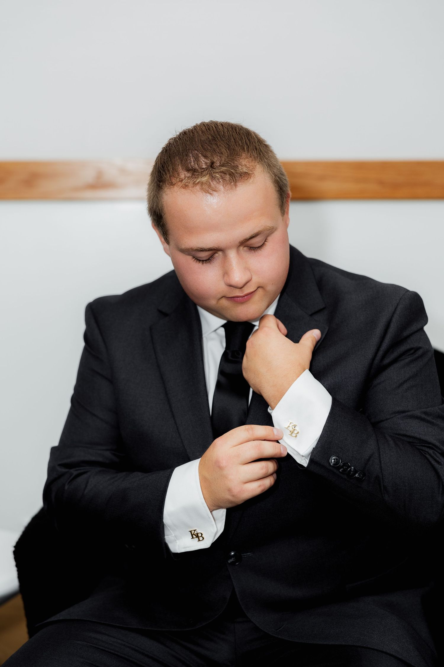Luxury wedding photo of groom adjusting cufflinks, capturing stylish, elegant, and detailed bridal party and wedding preparation photography