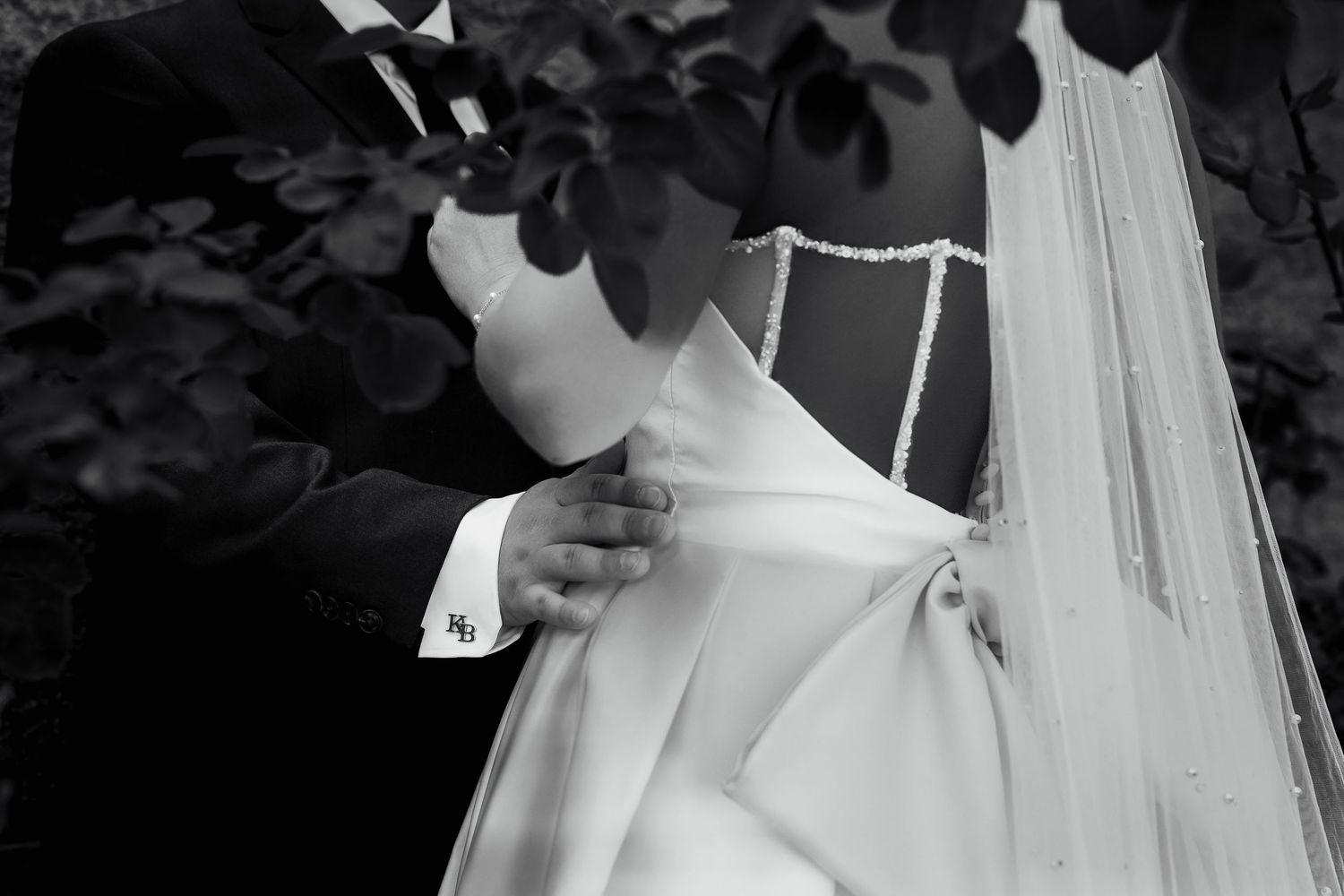 Luxury wedding photo of groom’s hand on bride’s waist, capturing intimate, romantic, and stylish bridal couple photography.