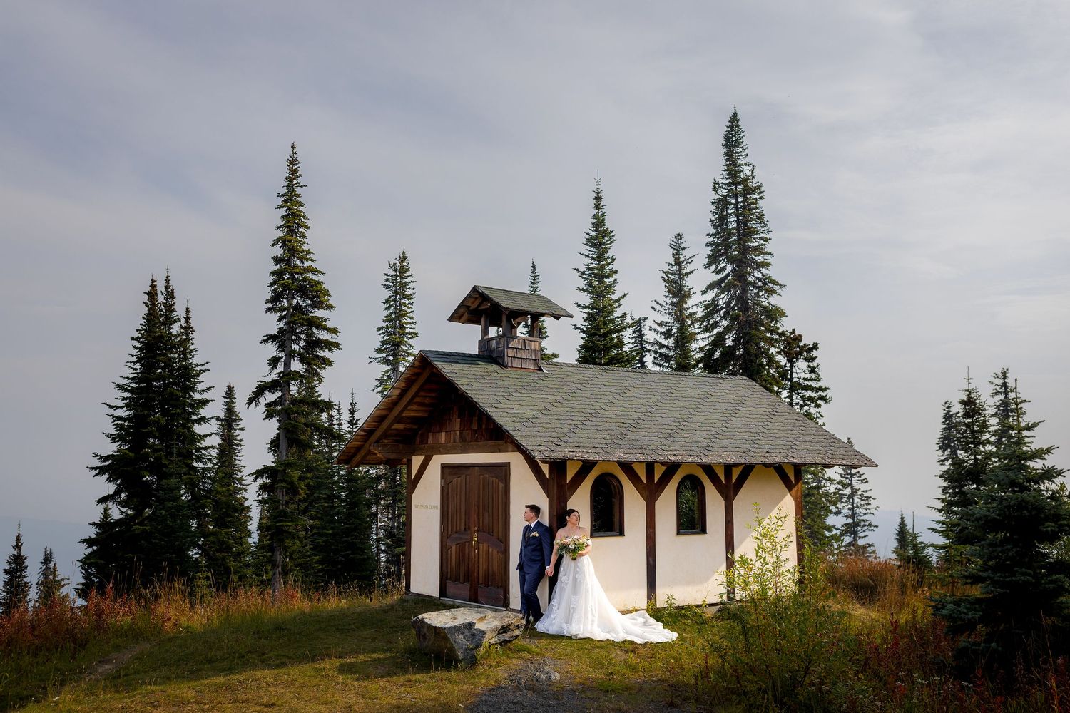 Luxury photo of couple doing portraits mid-mountain at Sun Peaks Resort, capturing romantic and stylish destination wedding photography.