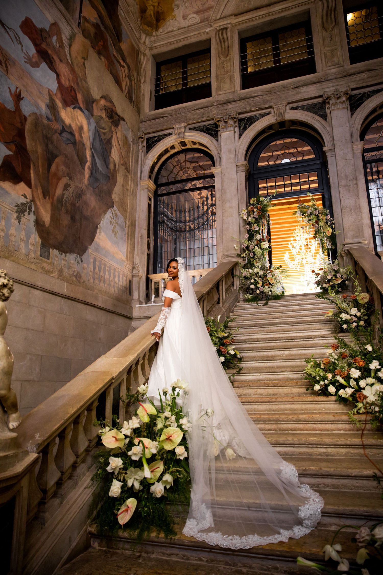 Luxury bridal portrait of bride on staircase at Ca’ Sagredo Hotel Venice, capturing elegant and stylish destination wedding photography.