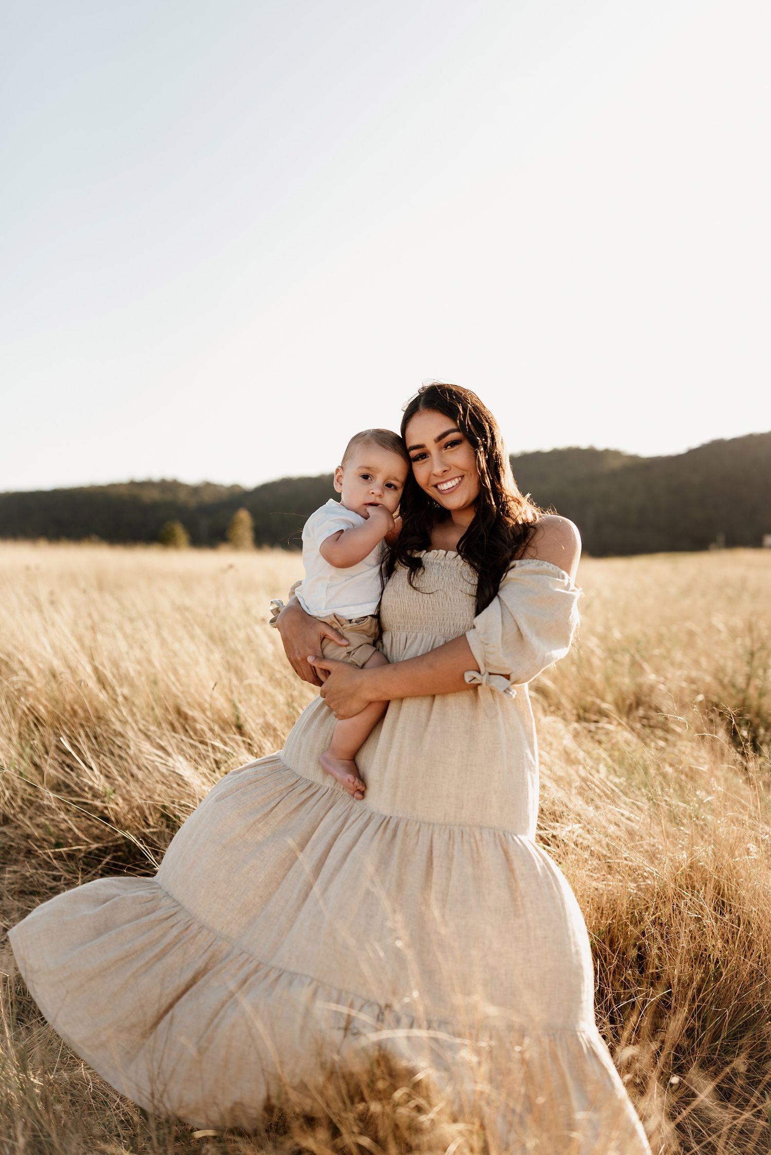 Mother and child in a field at sunset in Penrith