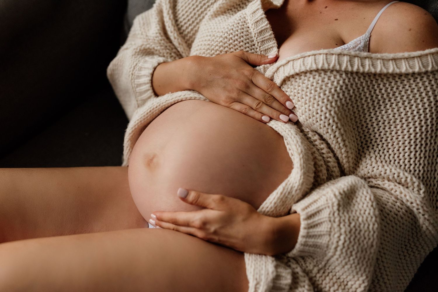 Mother cradling baby bump in Penrith
