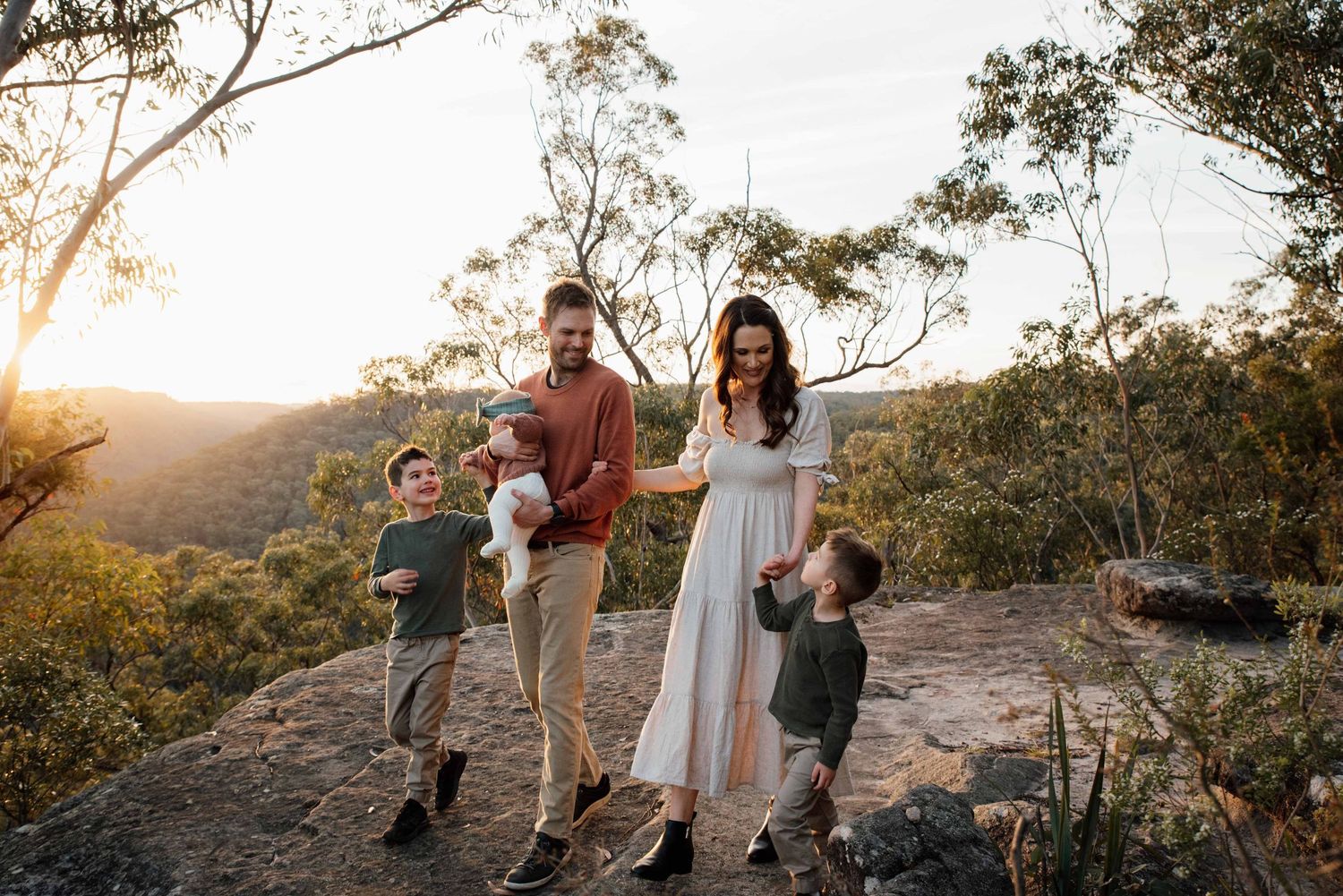 Family in Glenbrook Blue Mountains on a rock face during golden hour.