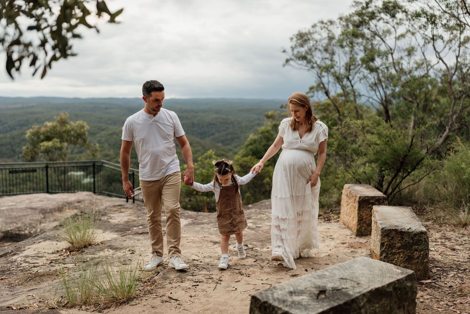 Family of three walking in the Blue Mountains with expectant mother