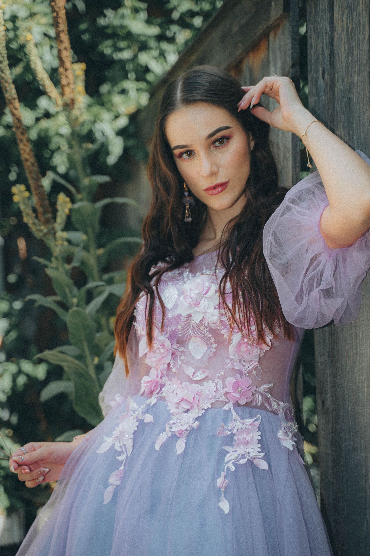 Ethereal portrait series in a lavender tulle gown with floral appliques against a natural outdoor backdrop.