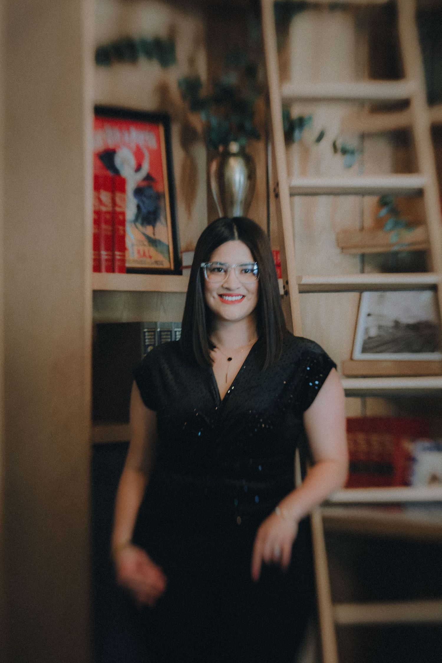 Series of four warm-toned candid photographs in a cozy indoor setting with bookshelves in the background.