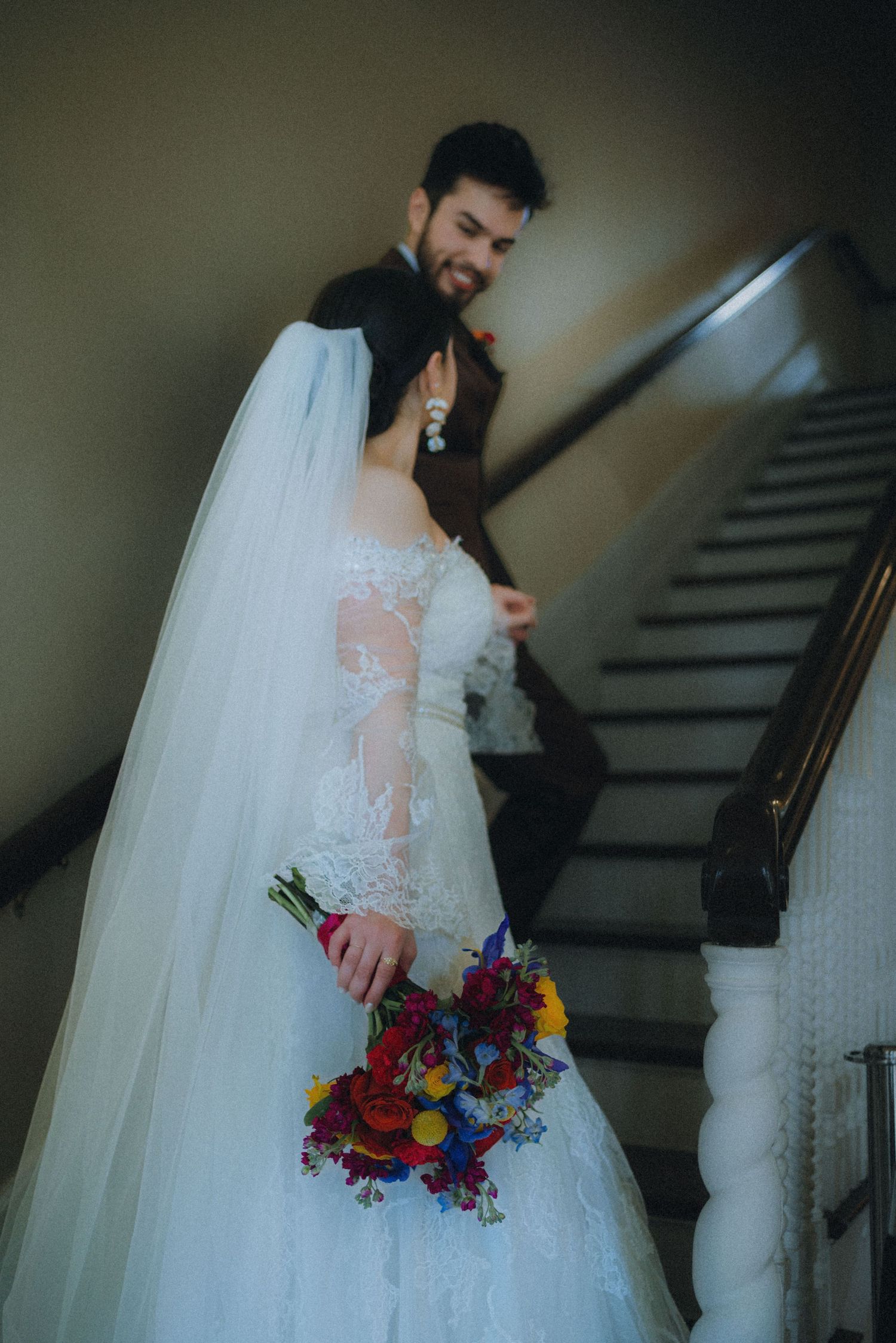 A person in a white wedding dress with a colorful bouquet poses on a staircase in an artistic series of photos.