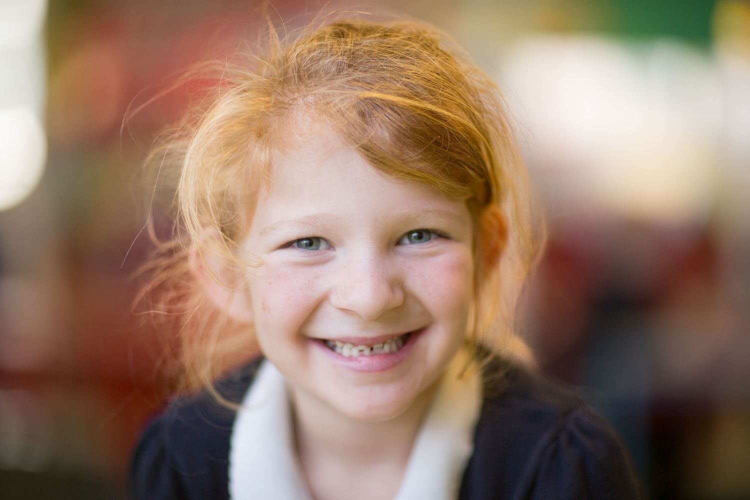 A series of seven portrait photos showing a smiling person with red hair against different backgrounds.