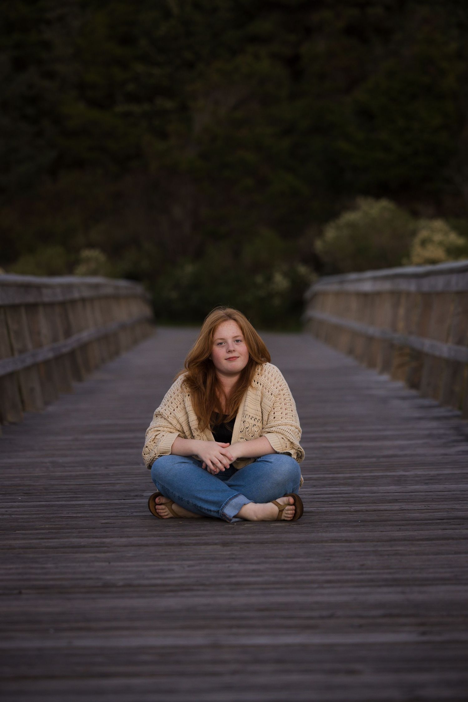 Campbell Mulligan sitting on wooden bridge