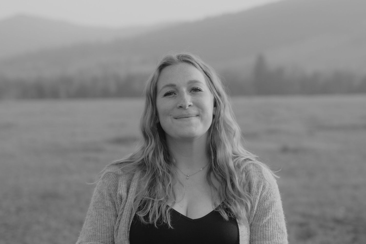 Dreamy black and white maternity photos in a mountain meadow.