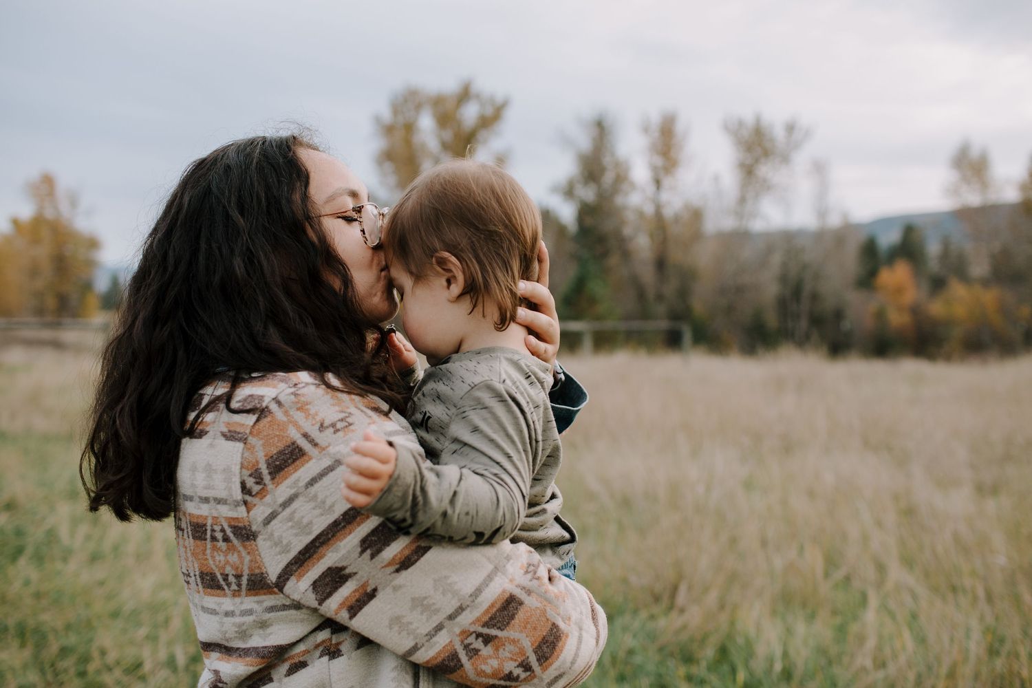 A touching moment of affection captured in a golden field during autumn.