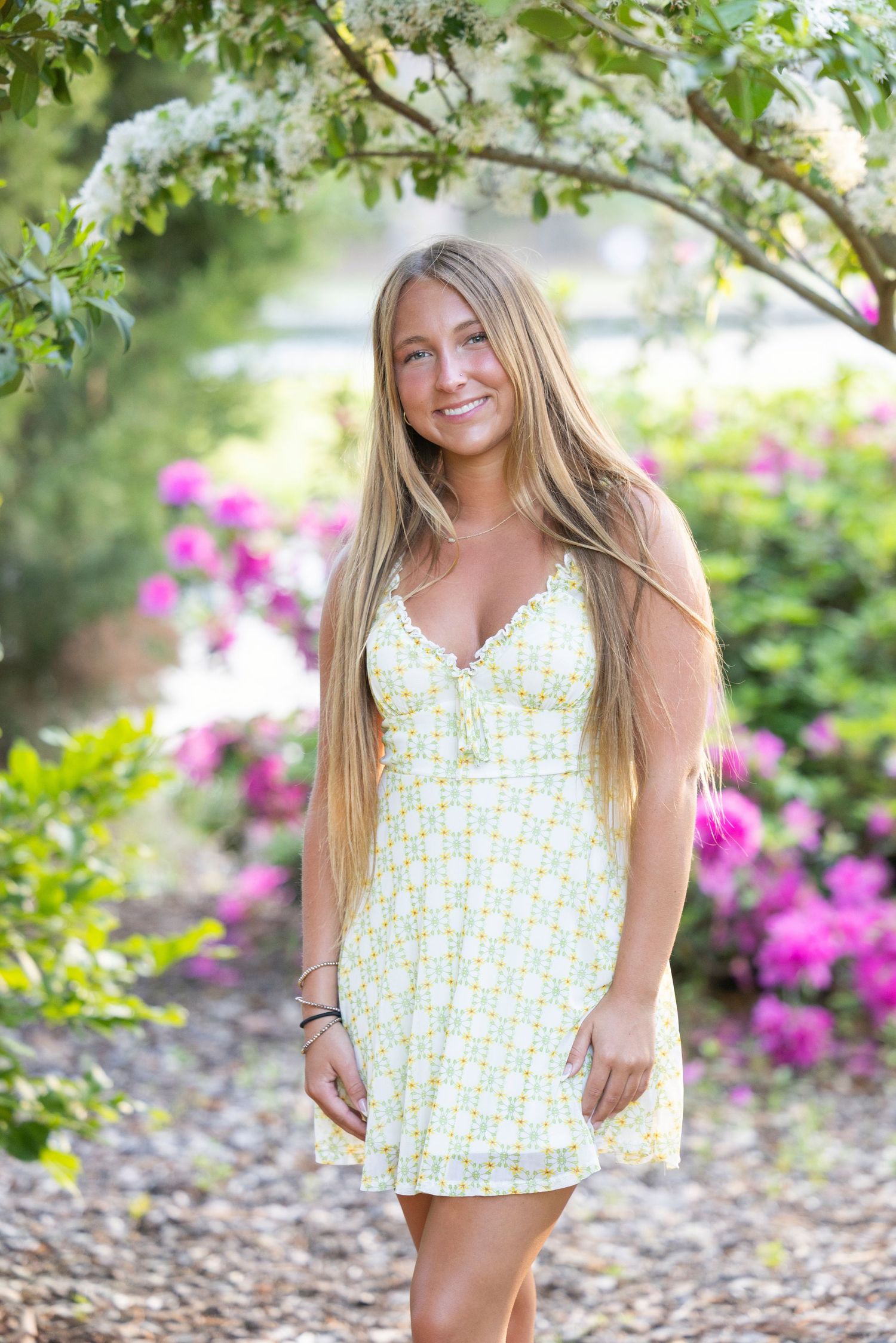A series of outdoor portraits in a garden setting with pink azalea flowers and green foliage in the background.