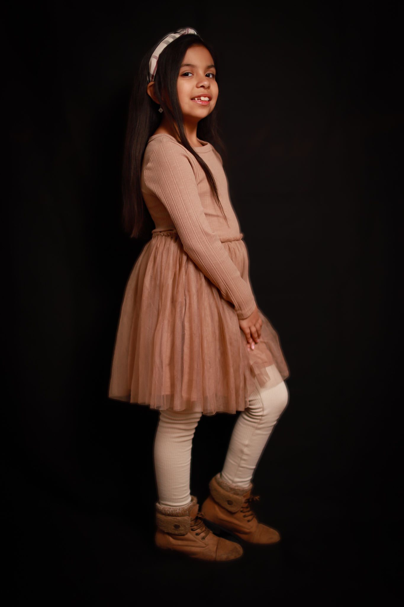 A kid girl in dress posing for portrait