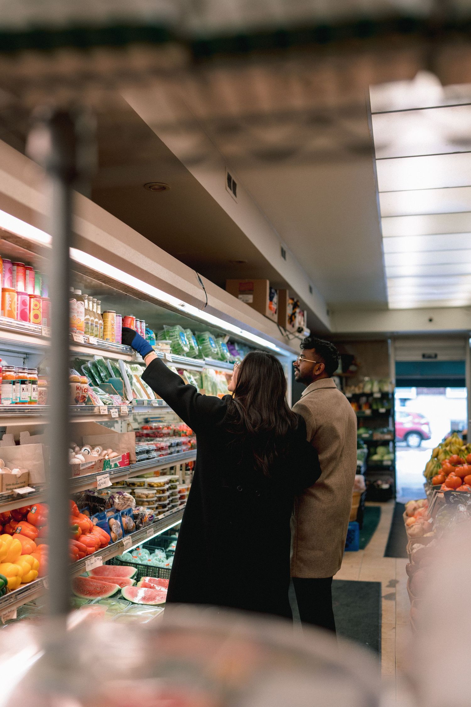 A sequence of blurry supermarket interior shots showing produce aisles and shoppers browsing merchandise.