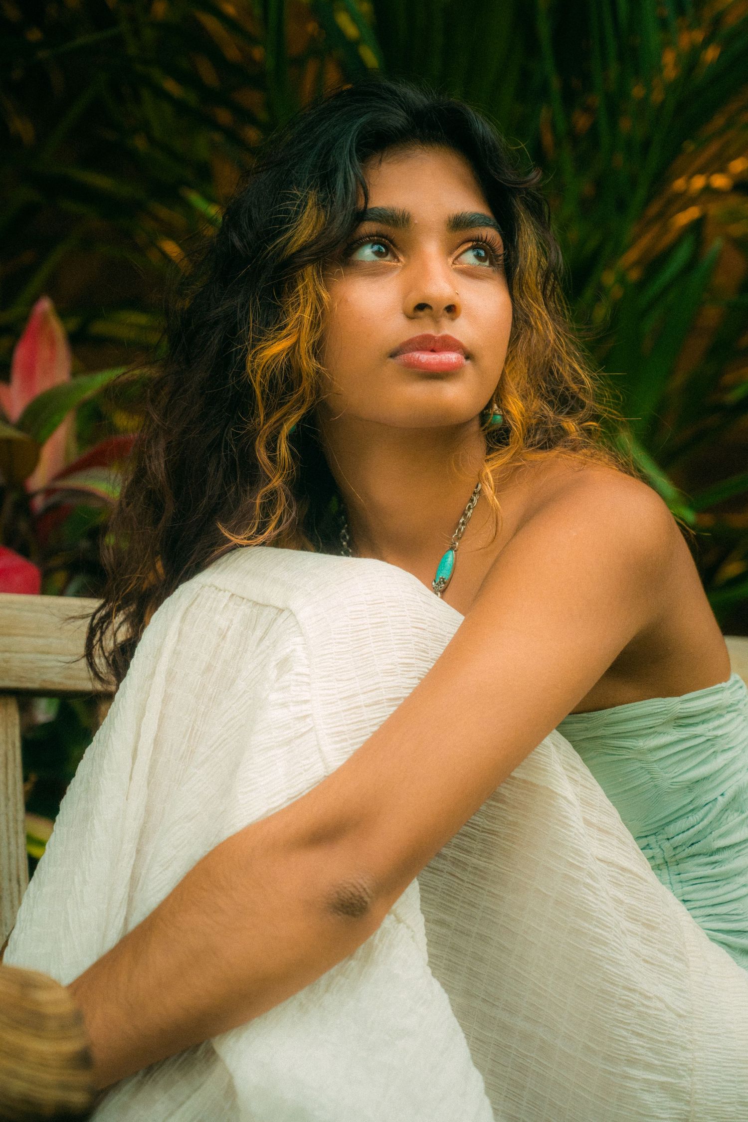 A dreamy outdoor portrait against tropical foliage in white clothing.