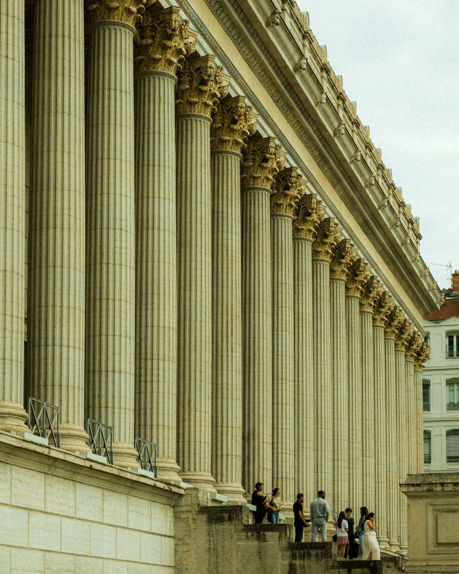 Impressive neoclassical colonnade with towering Corinthian columns stretching into the distance.