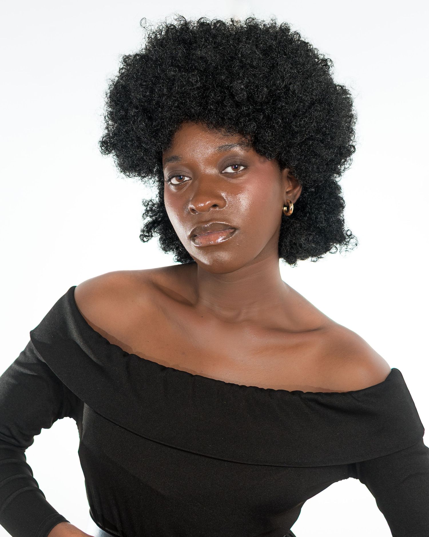 Studio portraits showing dynamic poses in black off-shoulder top against white background.