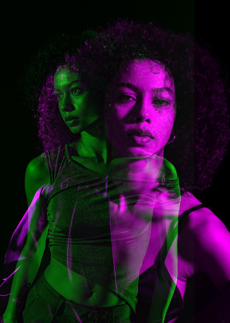 Multiple exposure dance portrait with purple and green lighting.