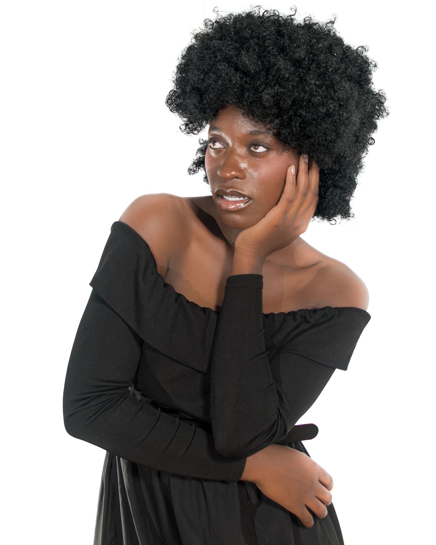 Artistic portrait poses in flowing black dress against clean white studio background.