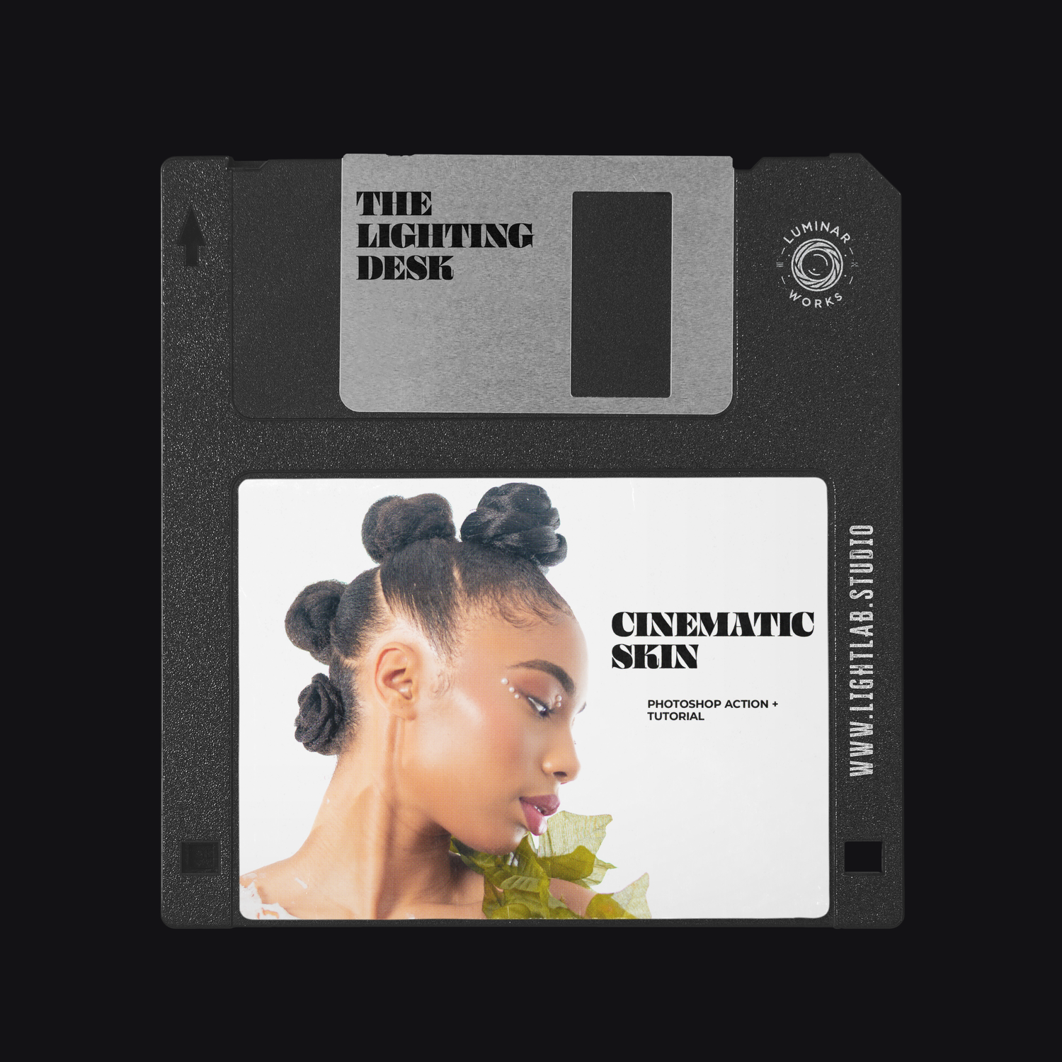 A stylized floppy disk design featuring a portrait with artistic hair buns and green foliage against a dark background.