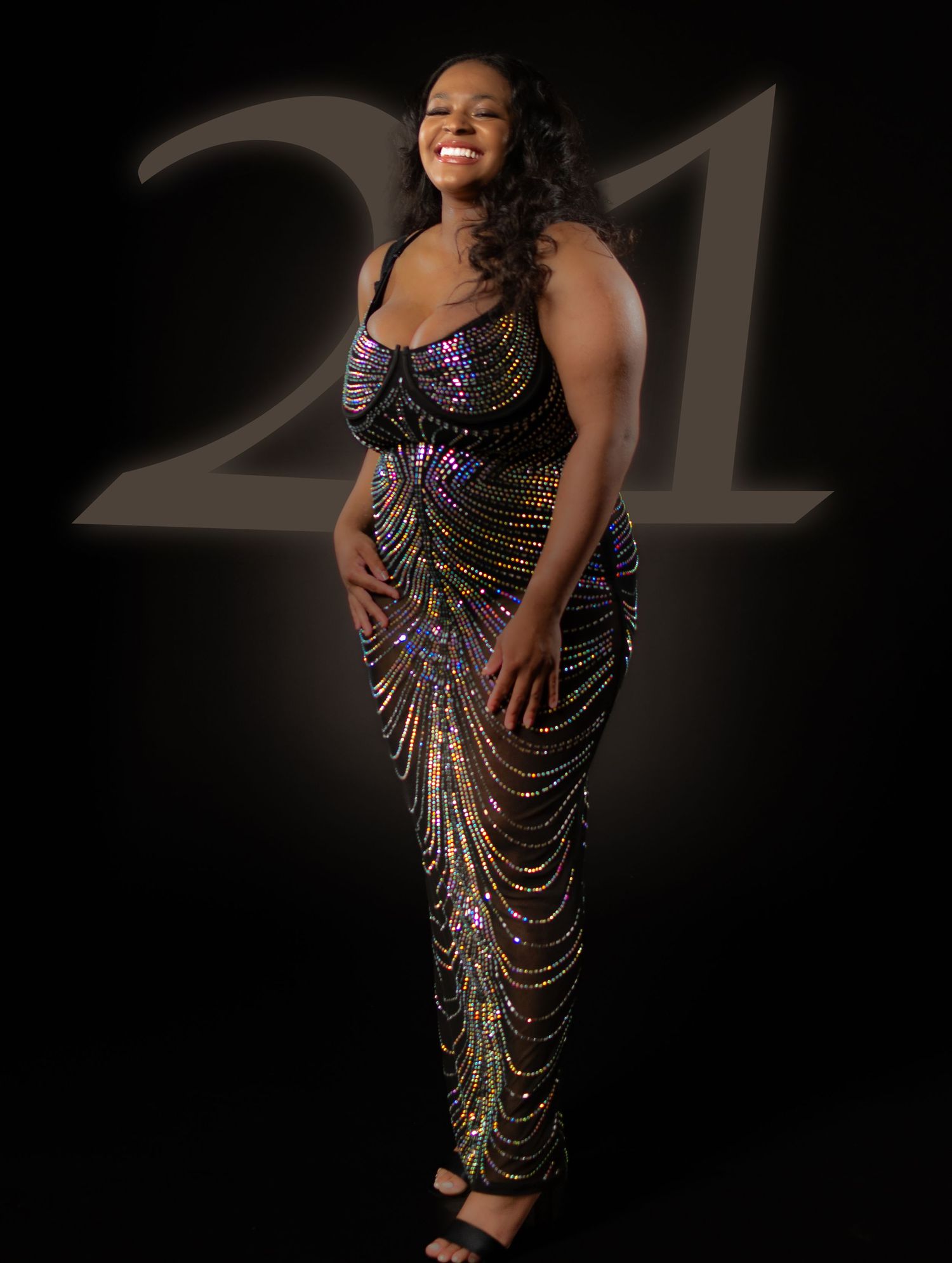 Glamour portrait in sparkling sequined dress against dark background.