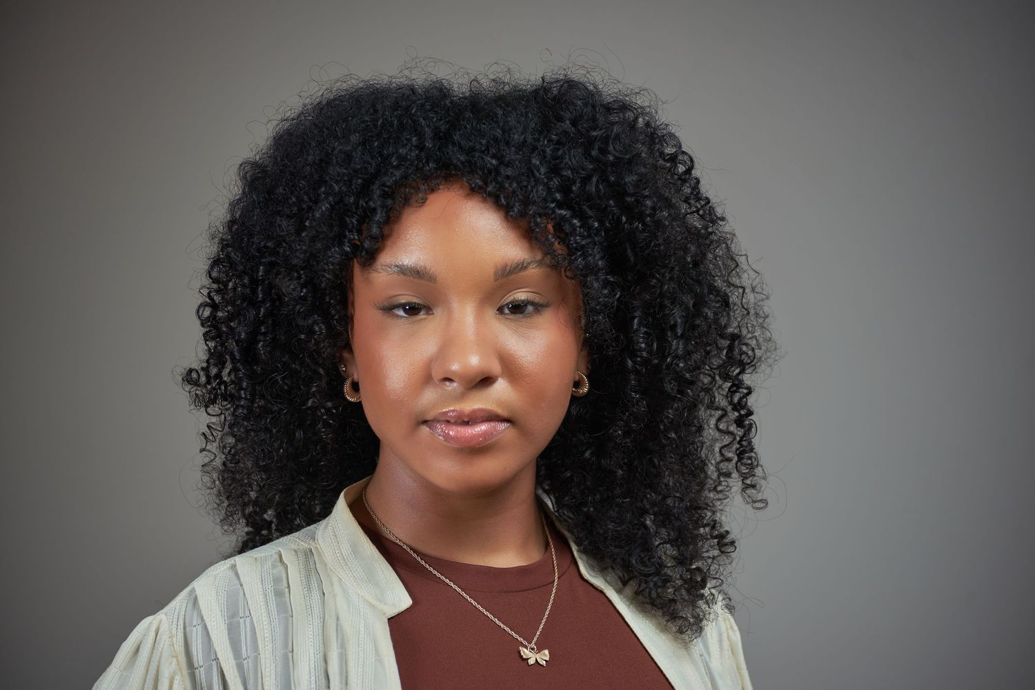 Professional studio portrait series with dramatic lighting against a dark gray background.