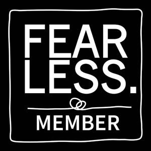 Black square badge with white text reading FEARLESS MEMBER, featuring a decorative border and interlinked rings symbol.