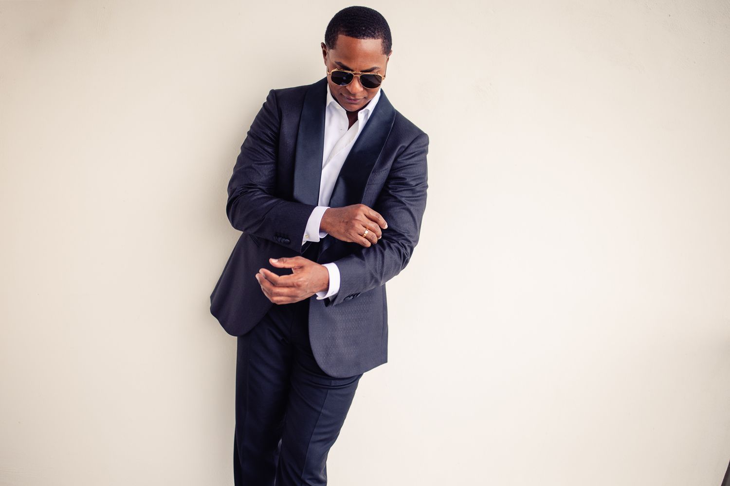 A stylish groom in a navy blue suit and sunglasses Cancun Wedding Photographer, Destination Wedding Cancun,