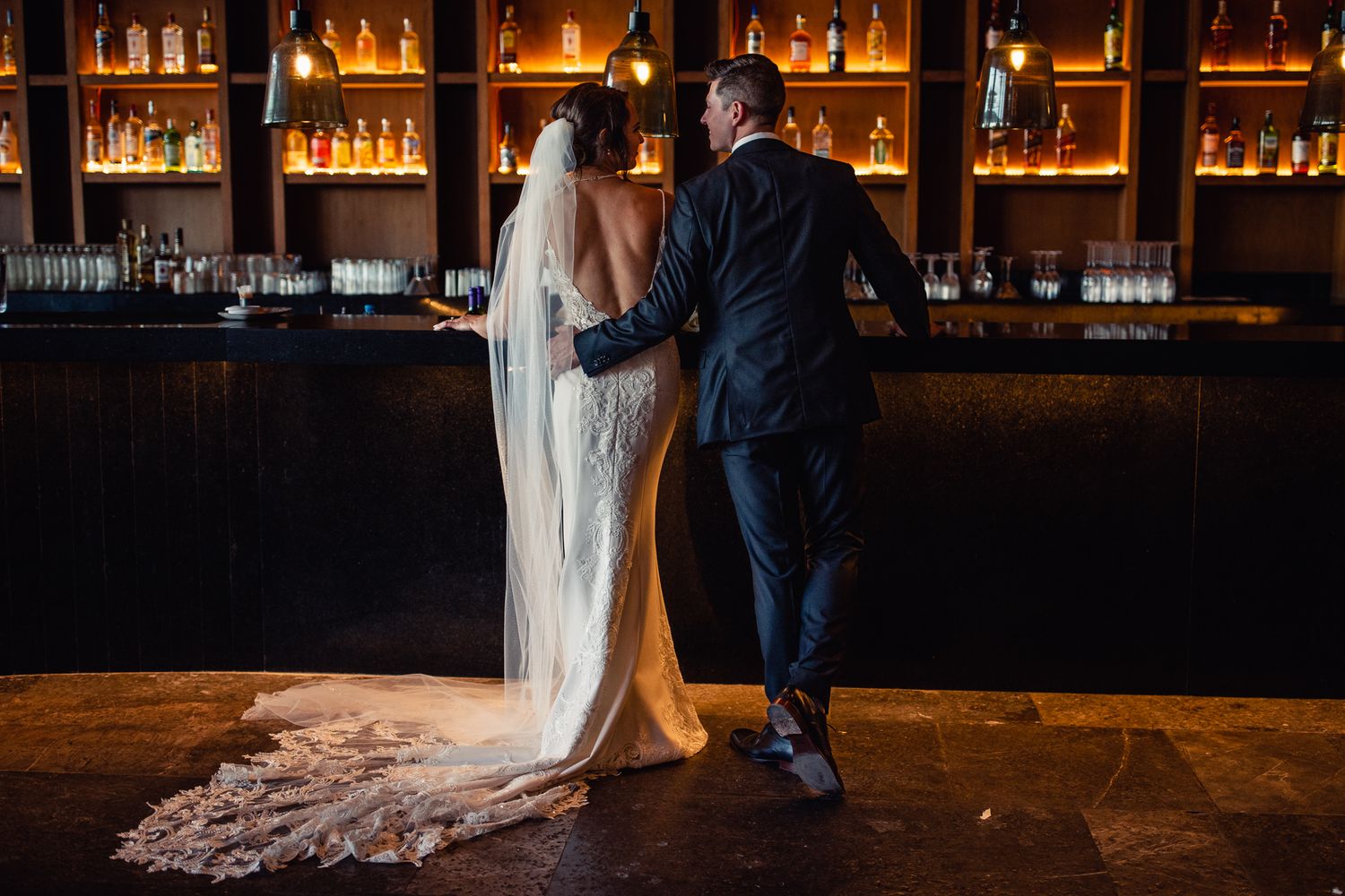 Bride and groom standing together at a bar, Cancun Wedding Photographer, Destination Wedding Cancun, PLaya Mujeres Excellence Hotel