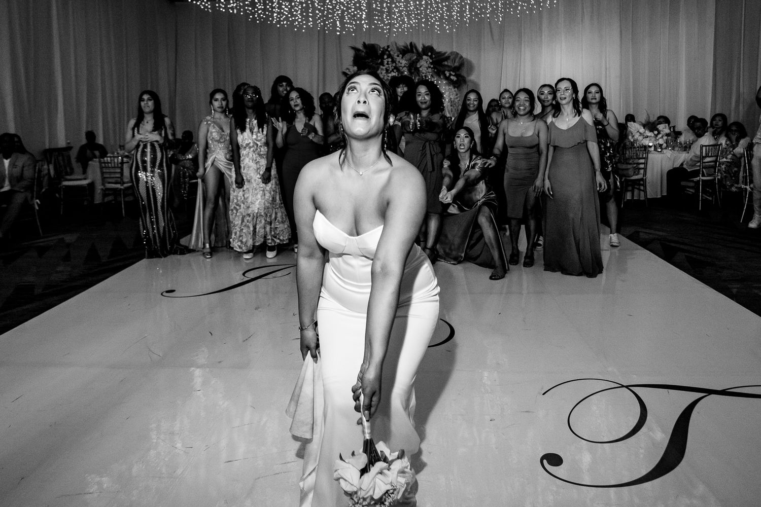 Bride tossing bouquet to guests on dance floor at elegant wedding reception Cancun Wedding Photographer, Destination Wedding Cancun,