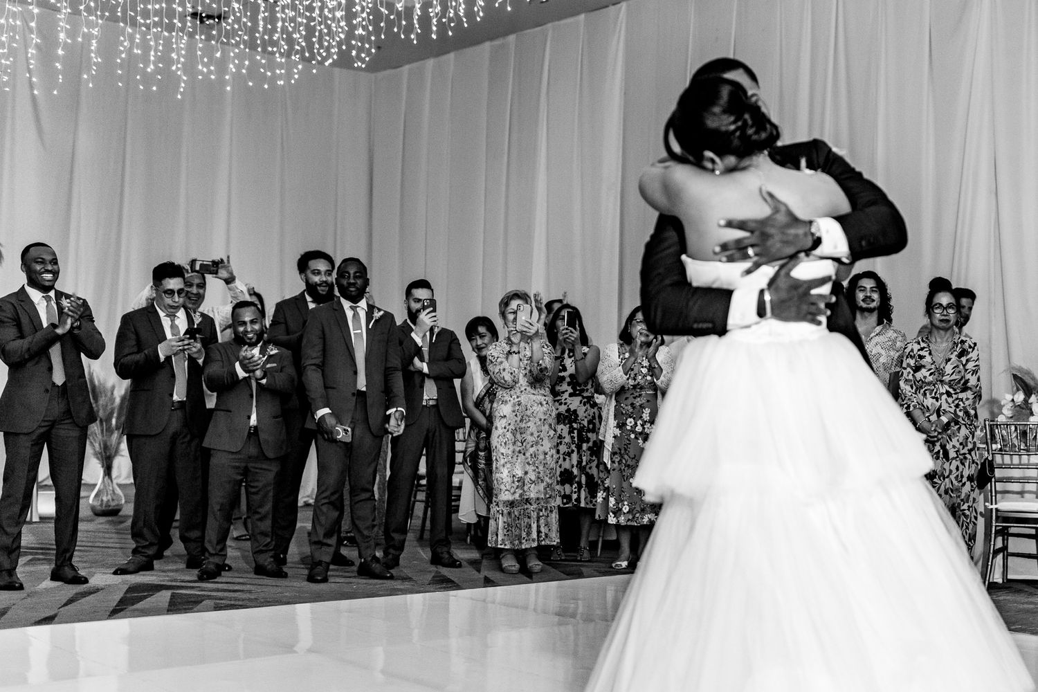 Black and white photo of bride and groom sharing first dance at elegant wedding reception. Cancun Wedding Photographer, Destination Wedding