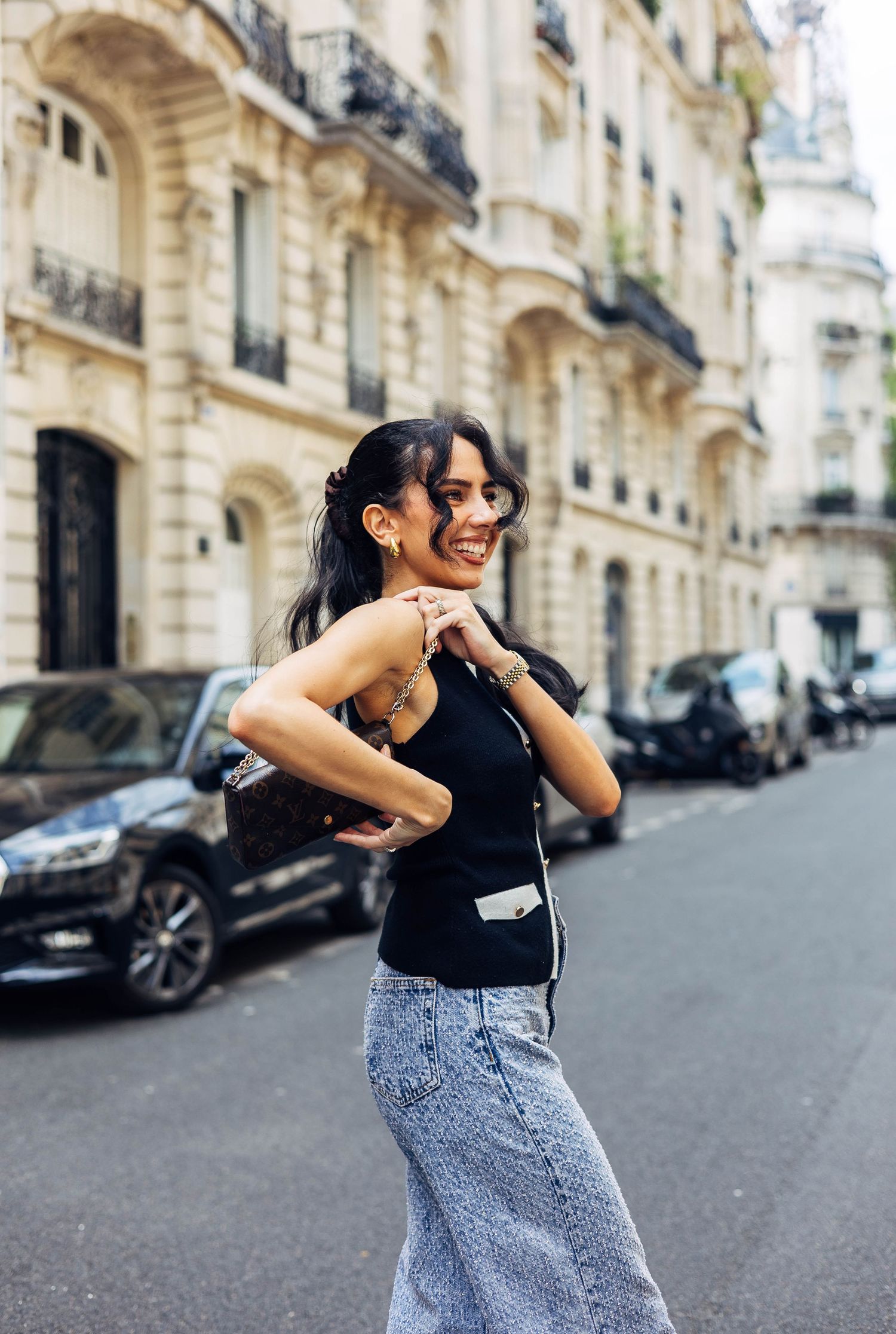 Casual street style photo on a Parisian street with denim and black top.