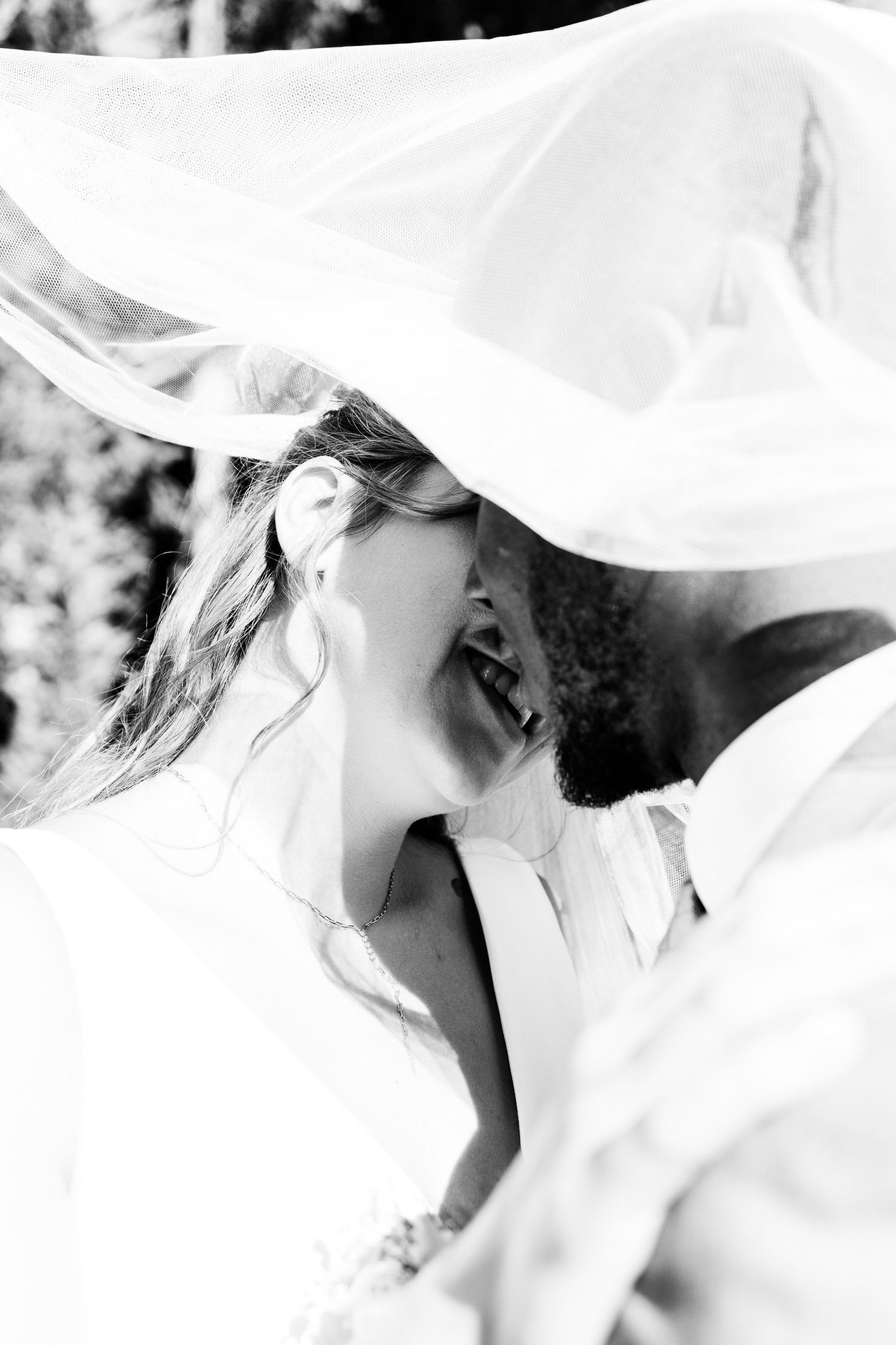 Romantic black and white wedding photos with flowing veil movement.