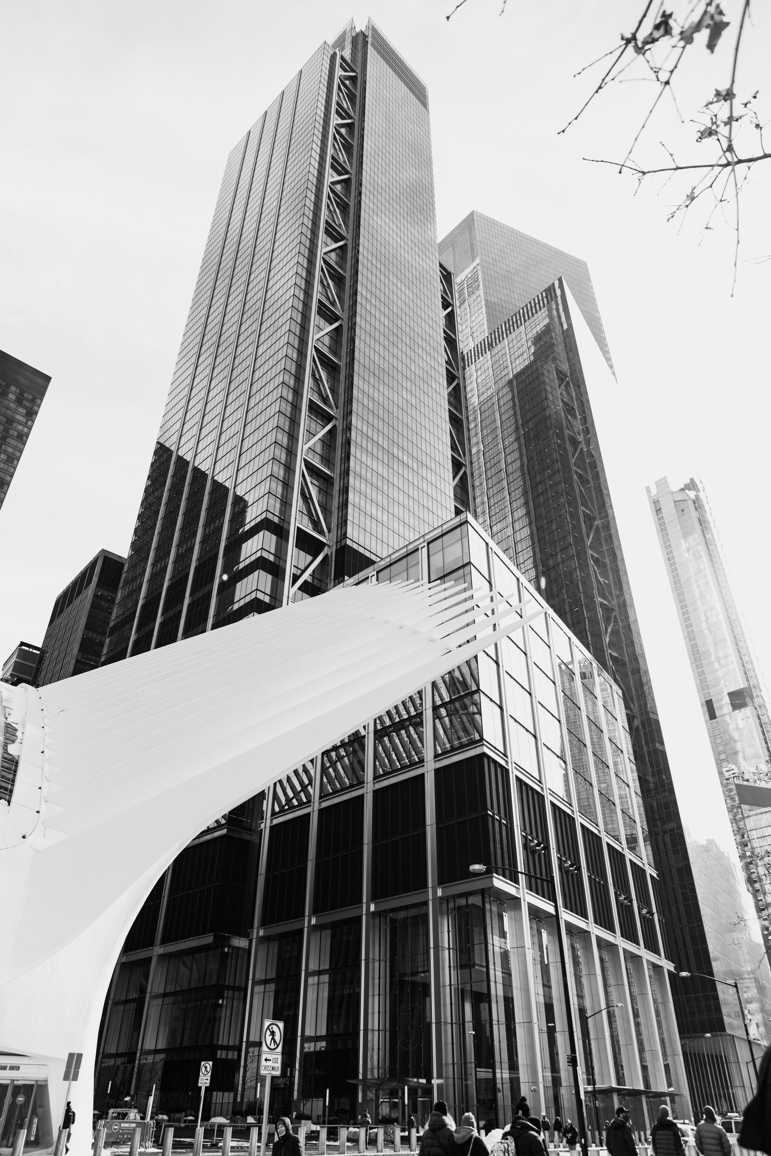 Angular black and white view of contemporary urban architecture with reflective glass surfaces.