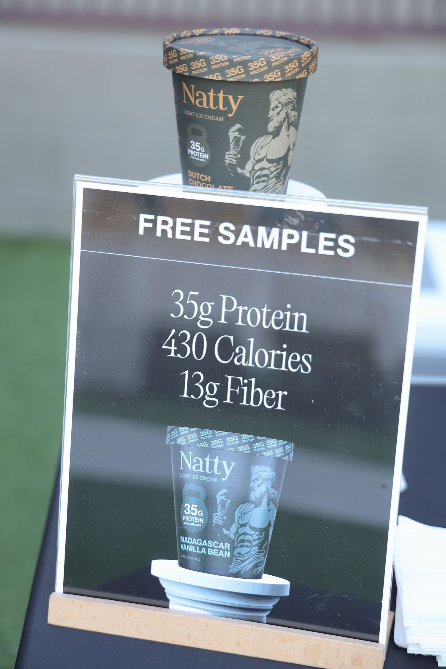 Product information signs showing nutritional facts and calorie content for Natty ice cream samples.