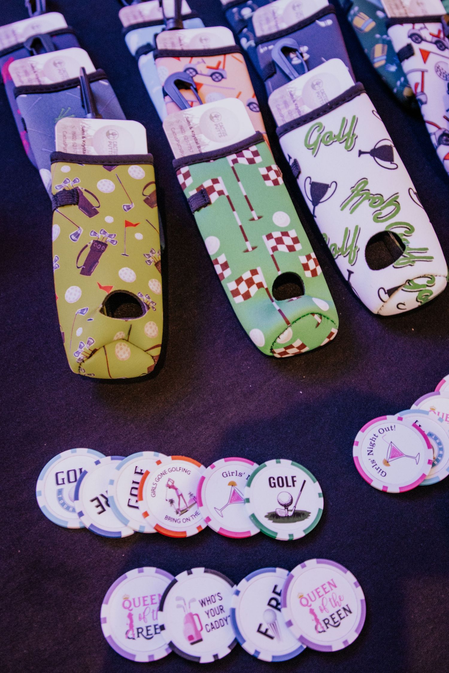 Golf-themed merchandise and poker chips displayed on a dark surface.