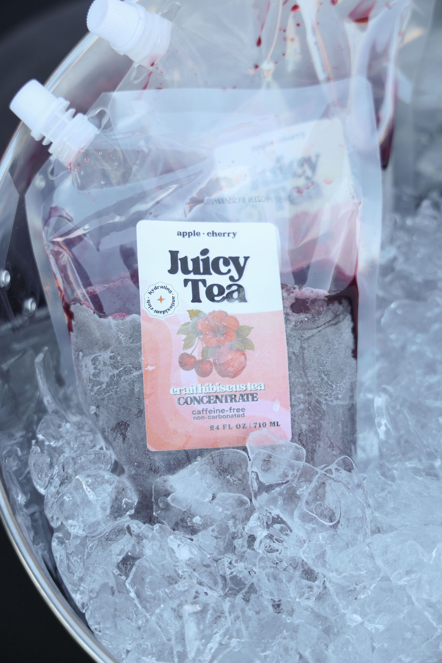 Tea bags with different flavor labels rest on a bed of crushed ice.