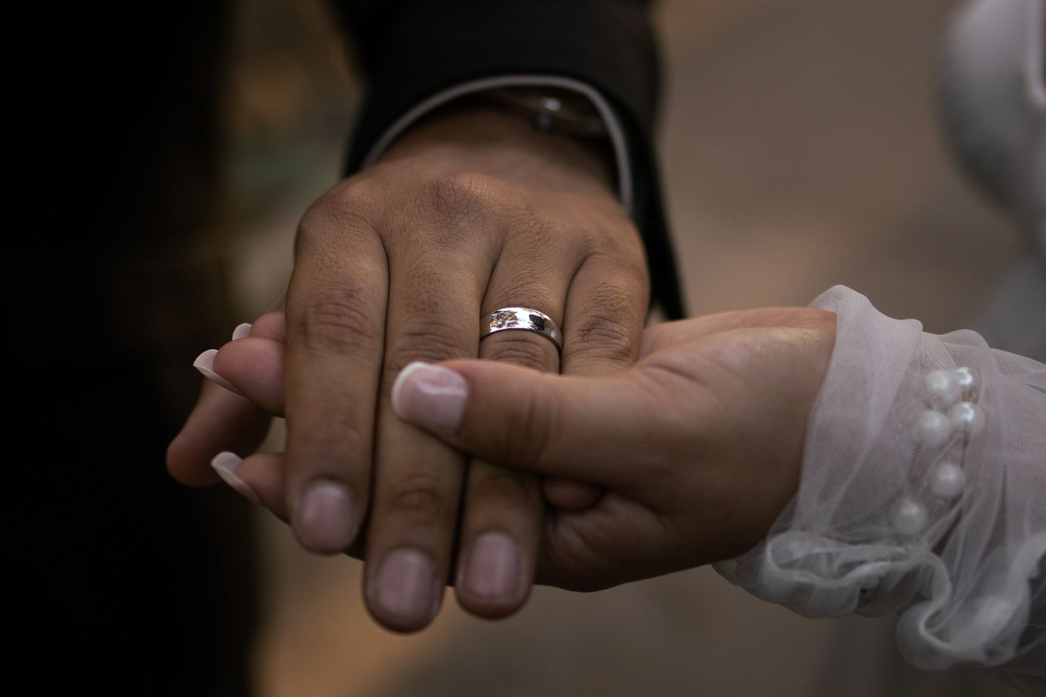 Wedding rings being exchanged between hands during an intimate ceremony.  At Rancho Carrillo