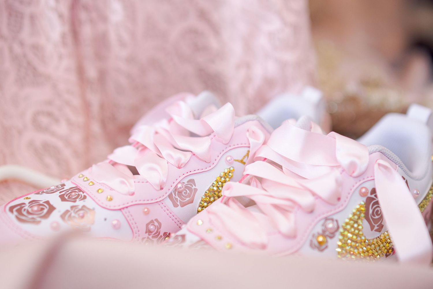 Delicate pink fabric with glittering embellishments and decorative details. At a Quinceañera