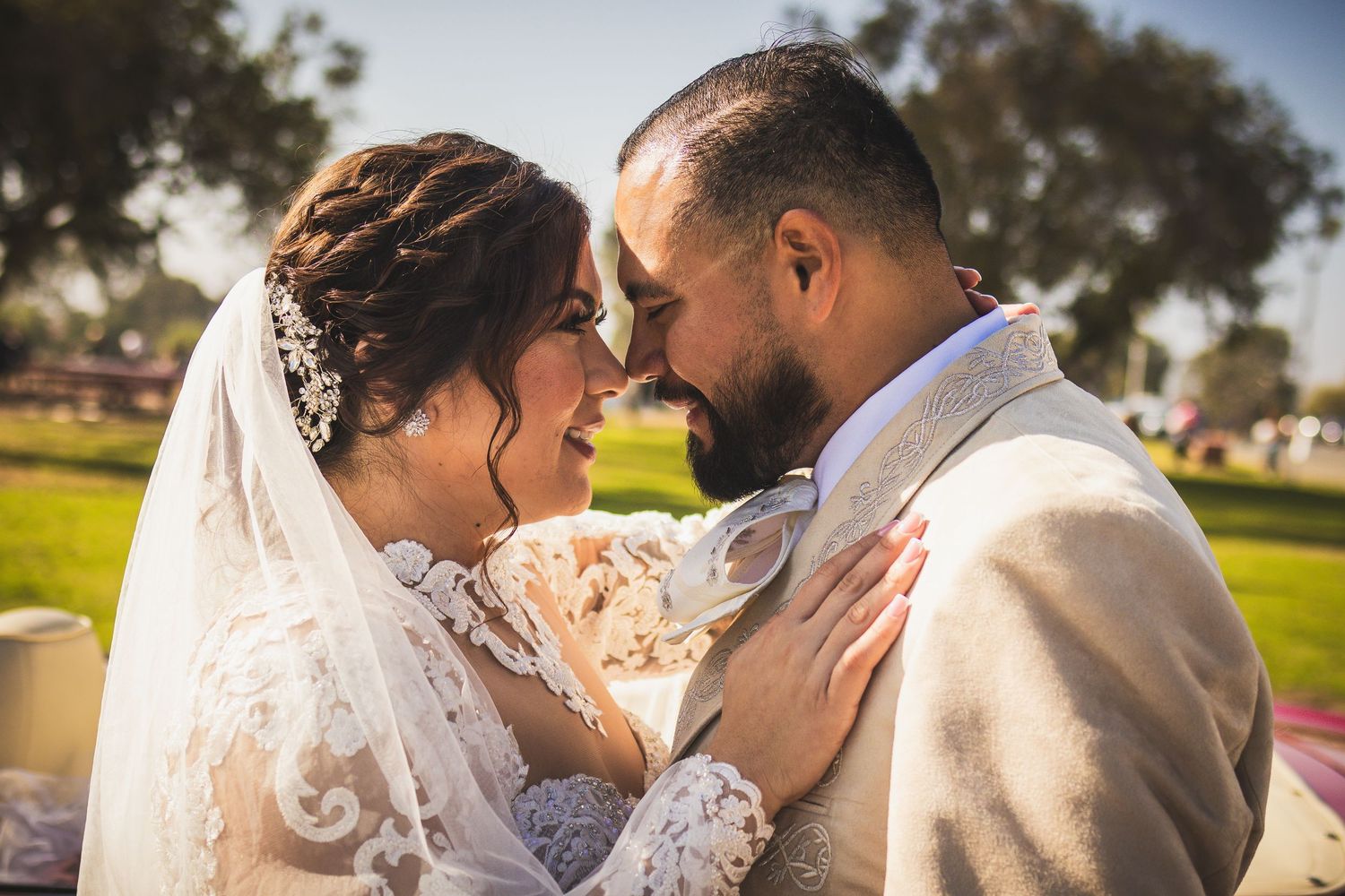 Romantic wedding couple sharing tender moments in outdoor setting. At San Luis Rey Parish celebrating a wedding
