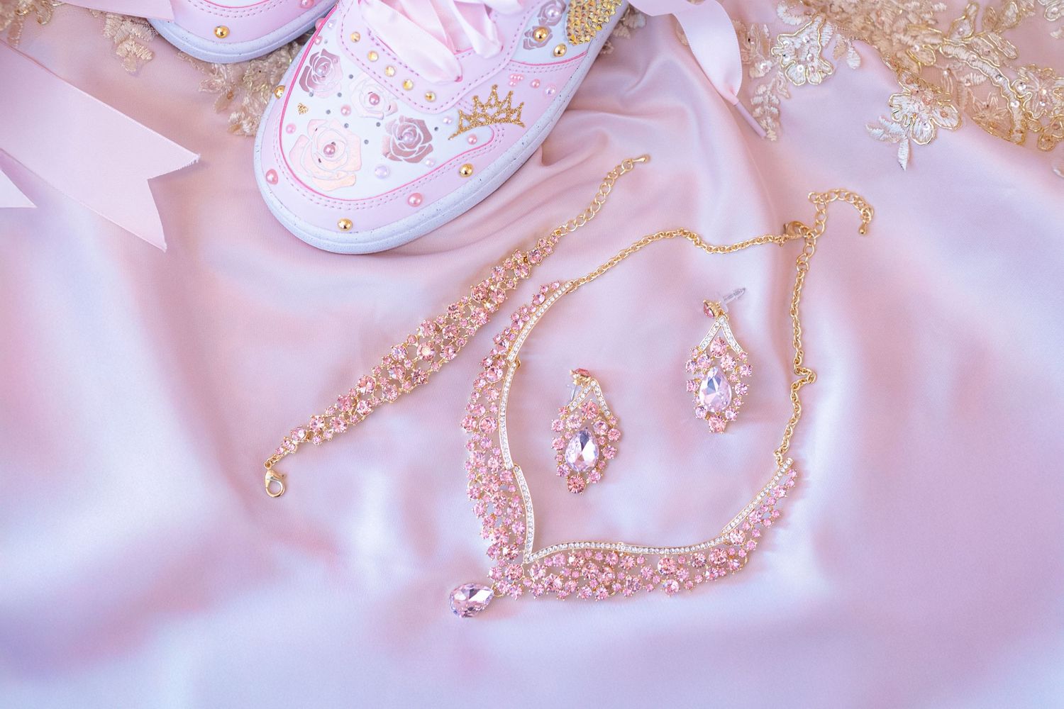Pink and white fabric with sparkly gold embellishments and decorative patterns. At a Quinceañera