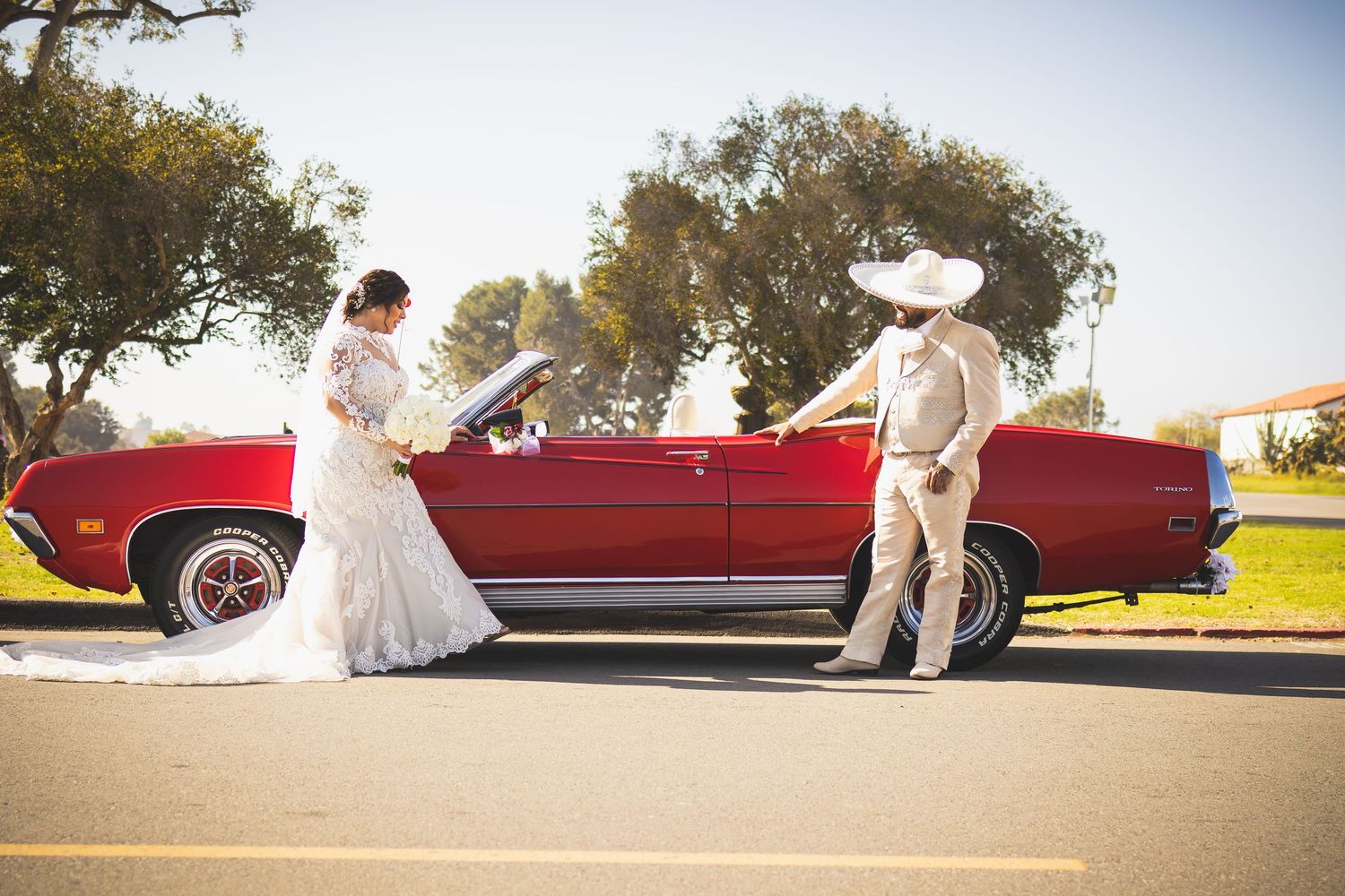 Wedding photo sequence with classic red car in outdoor setting. At San Luis Rey Parish celebrating a wedding
