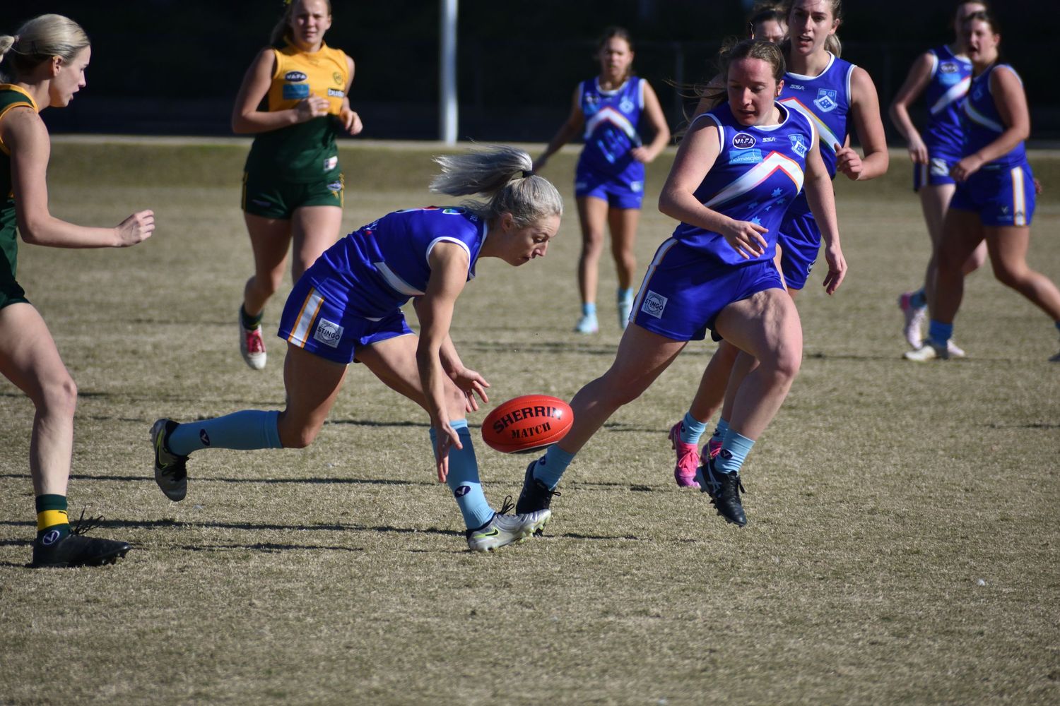 Picking the ball up off the ground - sports photography