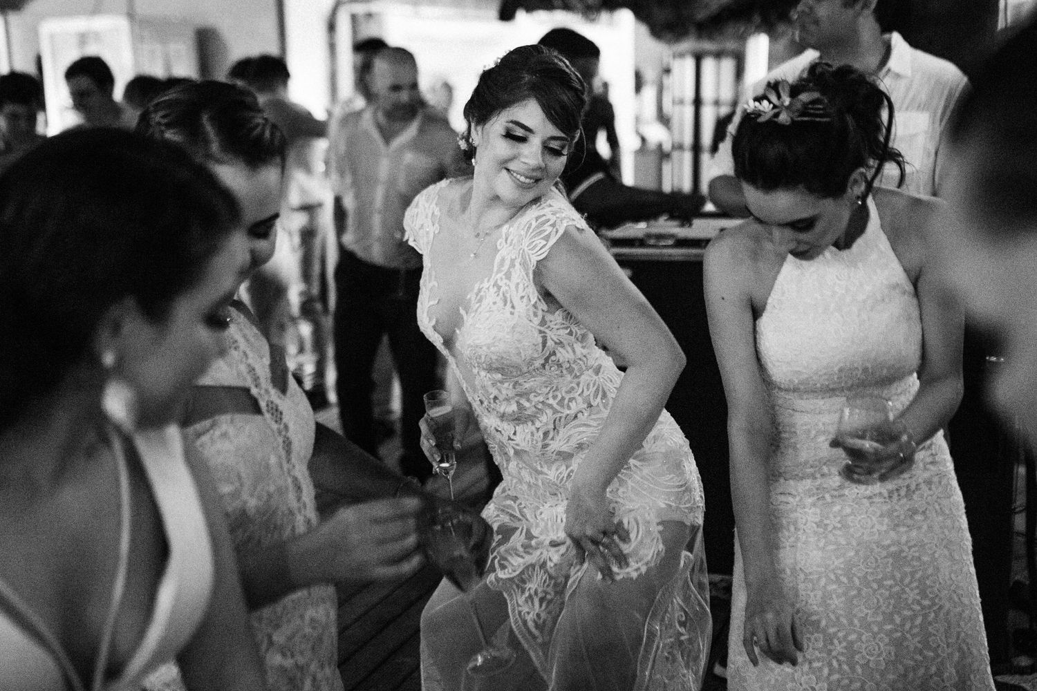 A series of black and white wedding photos showing intimate moments and reactions during an emotional celebration.